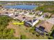 Aerial view of property with screened in lanai and solar panels overlooking the community lake at 18013 Polo Trl, Bradenton, FL 34211