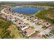 Aerial view of community boasting solar panels, tile roofs, and scenic lake views at 18013 Polo Trl, Bradenton, FL 34211