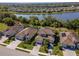 An aerial view shows the property's proximity to a scenic lake and well-kept landscaping at 18013 Polo Trl, Bradenton, FL 34211