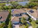 Beautiful home with solar panels, tile roof, paver driveway, lush landscaping, and a community lake view at 18013 Polo Trl, Bradenton, FL 34211