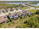 Aerial view of community showing tile roofs, green lawns, and a nearby lake providing a beautiful setting at 18013 Polo Trl, Bradenton, FL 34211