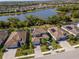Stunning aerial view of the community featuring well-maintained homes, lush landscaping, and a serene lake backdrop at 18013 Polo Trl, Bradenton, FL 34211