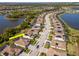 Aerial view of neighborhood with lake, tile roofs, solar panels, and lush landscaping at 18013 Polo Trl, Bradenton, FL 34211