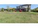 A beautifully landscaped backyard with a screened in porch, with plenty of space to enjoy at 18013 Polo Trl, Bradenton, FL 34211