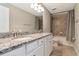 Bathroom featuring granite counters, double sinks, tub, and shower, a functional and luxurious space at 18013 Polo Trl, Bradenton, FL 34211