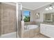 Bathroom boasts a tiled shower, soaking tub, and white cabinets, creating a spa-like atmosphere at 18013 Polo Trl, Bradenton, FL 34211