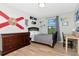 Bedroom features wood floors, desk, bed, and dresser offering a simple and inviting living space at 18013 Polo Trl, Bradenton, FL 34211