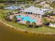 Aerial view of the pool area with mature palms and surrounding community amenities at 18013 Polo Trl, Bradenton, FL 34211