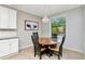 Cozy dining area boasts a wooden table, four chairs, a chandelier, and a window with a view at 18013 Polo Trl, Bradenton, FL 34211