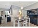 Dining room featuring chandelier, white cabinets, and blue hutch with wainscoting at 18013 Polo Trl, Bradenton, FL 34211