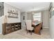Comfortable dining area features neutral walls, hardwood flooring, and a decorative cabinet and shelves at 18013 Polo Trl, Bradenton, FL 34211