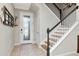 Bright foyer featuring a decorative front door, staircase, and neutral paint creating a welcoming entrance at 18013 Polo Trl, Bradenton, FL 34211