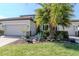 Beautiful home with a well-maintained lawn, two-car garage, and tropical landscaping at 18013 Polo Trl, Bradenton, FL 34211