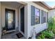Close up of the home's entryway, front door and adjacent windows with decorative shutters at 18013 Polo Trl, Bradenton, FL 34211