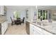 Open-concept kitchen with granite countertops, stainless steel appliances, and a cozy dining area at 18013 Polo Trl, Bradenton, FL 34211