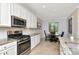 Modern kitchen with granite countertops, stainless steel appliances, and a view to the eat in kitchen at 18013 Polo Trl, Bradenton, FL 34211