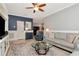 Comfortable living room with a ceiling fan, area rug, and decorative wall accents at 18013 Polo Trl, Bradenton, FL 34211