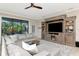 Comfortable living room with large windows, a ceiling fan, and decorative built-in shelving at 18013 Polo Trl, Bradenton, FL 34211