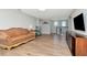 Spacious living room with wood floors, a leather couch, and entertainment center at 18013 Polo Trl, Bradenton, FL 34211
