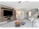 Comfortable living room with entertainment center seamlessly connected to the kitchen and foyer at 18013 Polo Trl, Bradenton, FL 34211