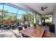 Enclosed patio with outdoor furniture, dining area, and scenic views at 18013 Polo Trl, Bradenton, FL 34211