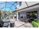 Enclosed patio with outdoor furniture, dining area, and scenic views at 18013 Polo Trl, Bradenton, FL 34211