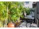 Outdoor kitchen area featuring stainless grill surrounded by lush landscaping on a stone patio at 18013 Polo Trl, Bradenton, FL 34211