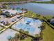 Community view showcasing tennis courts, playground, pool, and clubhouse in a lakeside community at 18013 Polo Trl, Bradenton, FL 34211