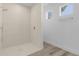 Modern bathroom featuring a walk-in shower with tiled walls and a large window at 2364 Carpenter Ln, North Port, FL 34286