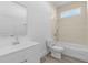 Modern bathroom features a tub with a shower, white vanity, and tiled walls at 2364 Carpenter Ln, North Port, FL 34286