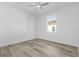 Cozy bedroom featuring a ceiling fan and a large window providing natural light at 2364 Carpenter Ln, North Port, FL 34286