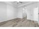 A bright bedroom offers wood floors, a large window, and a modern ceiling fan at 2364 Carpenter Ln, North Port, FL 34286