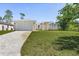 Charming one-story home features a well-manicured lawn, paved driveway, and attached two-car garage at 2364 Carpenter Ln, North Port, FL 34286