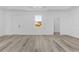An airy living room offers wood flooring, white walls, and recessed lighting at 2364 Carpenter Ln, North Port, FL 34286