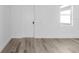 Bright room features modern flooring, white trim, and a large window at 2364 Carpenter Ln, North Port, FL 34286