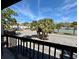 Outdoor balcony with views of palm trees and tennis courts at 2632 Hidden Lake N Dr # E, Sarasota, FL 34237