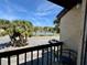 Balcony view overlooking palm trees and a parking lot at 2632 Hidden Lake N Dr # E, Sarasota, FL 34237