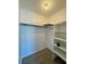 Walk-in closet with built-in shelving and ample space for organization at 2632 Hidden Lake N Dr # E, Sarasota, FL 34237