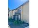 Exterior of two-story condo unit with a balcony and manicured shrubs at 2632 Hidden Lake N Dr # E, Sarasota, FL 34237