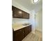 Functional kitchen features stainless sink, ample counter space and wood-look flooring at 2632 Hidden Lake N Dr # E, Sarasota, FL 34237