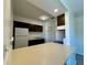 Well-lit kitchen features stainless sink, modern lighting and a breakfast bar, great for entertaining at 2632 Hidden Lake N Dr # E, Sarasota, FL 34237