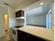 Updated kitchen area with stainless appliances, counter seating and an open floorplan at 2632 Hidden Lake N Dr # E, Sarasota, FL 34237