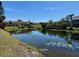 Scenic view of a pond with lily pads, reflecting the clear blue sky in a waterside community at 2632 Hidden Lake N Dr # E, Sarasota, FL 34237