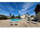 Community pool with ample lounge seating and lush tropical landscaping at 2632 Hidden Lake N Dr # E, Sarasota, FL 34237