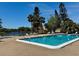 Community pool with lounge seating and lush landscaping in a tranquil setting at 2632 Hidden Lake N Dr # E, Sarasota, FL 34237