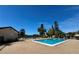 Community pool with lounge seating, overlooking a scenic water view at 2632 Hidden Lake N Dr # E, Sarasota, FL 34237