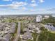 An aerial view of a charming community with palm trees, residential buildings, and serene lake views in a coastal setting at 2908 Fiddlers Bnd, Palmetto, FL 34221