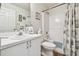 Bathroom with a white vanity, toilet, and a shower-tub combination with curtain at 2908 Fiddlers Bnd, Palmetto, FL 34221