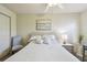 Cozy bedroom featuring a queen bed, ceiling fan, and a soothing beach-themed art piece at 2908 Fiddlers Bnd, Palmetto, FL 34221