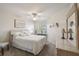 Bright bedroom with a queen bed, ceiling fan, and a neutral color palette at 2908 Fiddlers Bnd, Palmetto, FL 34221